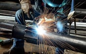 Image of a man welding pipe for water treatment 175x109